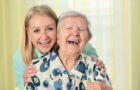 caregiver and senior laughing