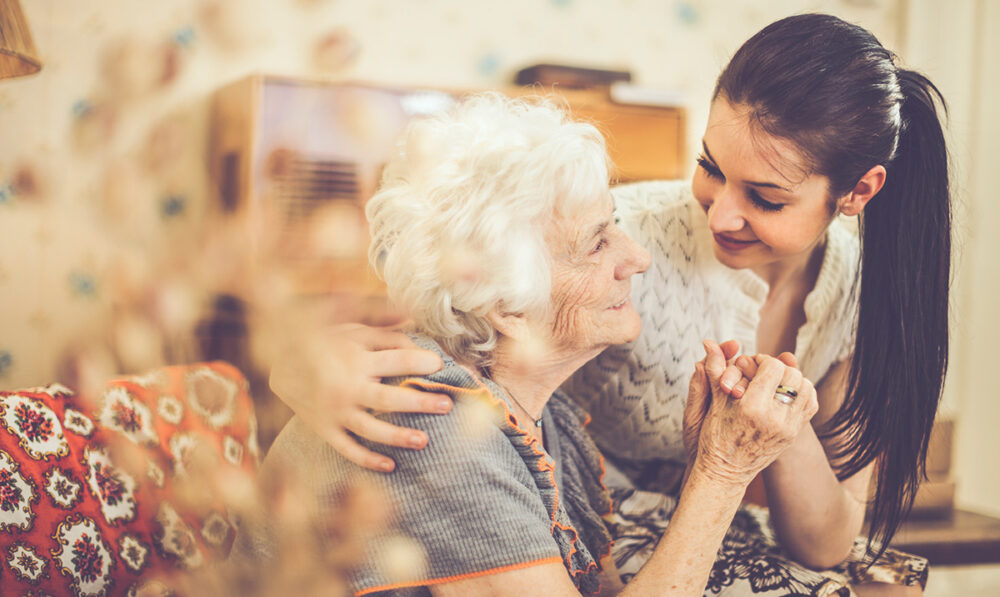 senior woman holding hands with woman