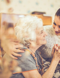 senior woman holding hands with woman