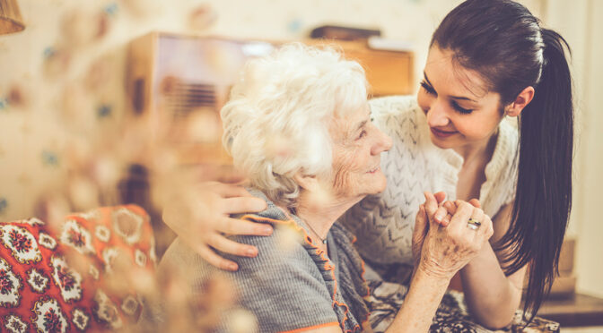 senior woman holding hands with woman